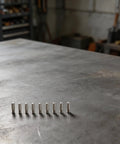 10 copper electrodes from the 26-Pack Plasma Cutter Consumables Kit For AG60 SG55 CUT55 on a metal surface.