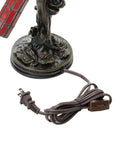 Close-up of the bronze-toned tree base with floral details and cord of Stained Glass Bird Accent Lamp With Tiffany Style Vibe, Blue Jay Design