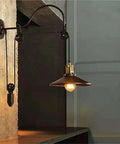 Adjustable Iron Wall Sconce With Smooth Glide Pulley Wheel And Clear Glass Shade For Soft Cozy Ceiling Lighting featuring a sleek design.