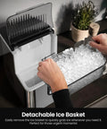 Hands holding detachable ice basket filled with nugget ice from Rapid Chill Countertop Nugget Ice Maker Churns Out 35 Pounds Daily.