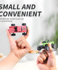 Hands holding Mini 1 To 64 Scale Monster RC Truck With Lights 2 Point 4GHz Remote Adjustable Speed And Steering Grey