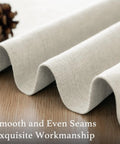 Close-up view of Soft Faux Linen Curtains 63 Inch Long material showing smooth seams and heather ivory color texture on wood surface.