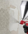 Pro Level Air Spray Gun Kit With Swap Out Three Liter And Six Liter Tanks delivering smooth atomization on a wall surface.