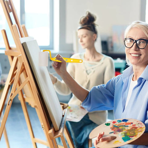 No Sweat Home Painting Kit Featuring Quick Coverage Sponge Rollers Combined With Versatile Bristle Brushes Designed For Smooth Wall Application And Relaxed Weekend Renovations, woman painting on canvas with sponge roller.