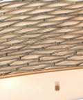 Close-up of Sculptural Oval Linear Pendant Light In Slick Hammered Ore Finish With Six Glowing Bulbs and Soft Fabric Shades.