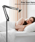 One Second Magnetic Bedside Phone Holder With Adjustable Arm for laying down, shown bedside in use by a woman in bed.
