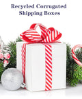 White box with red ribbon surrounded by holiday decor, representing 6x6x6 Shipping Boxes For Small Biz, 40 Pack White Corrugated Cardboard Boxes.