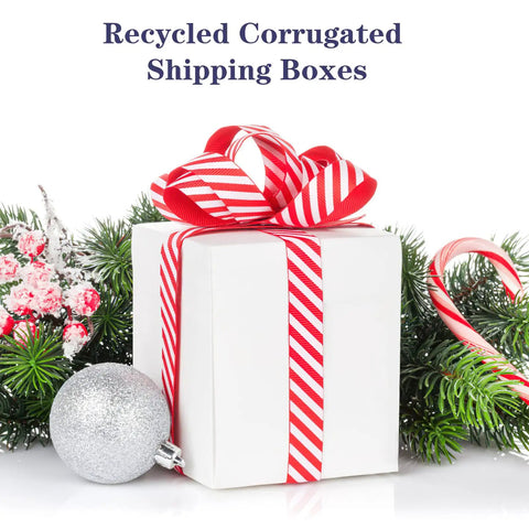 White box with red ribbon surrounded by holiday decor, representing 6x6x6 Shipping Boxes For Small Biz, 40 Pack White Corrugated Cardboard Boxes.