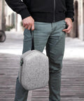 Man holding grey Hard Carrying Case For Quest 3S And Quest 3, Quest 2 And Vision Pro VR Headset With Controllers, travel-ready design