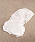 10 Pcs Disposable Nonwoven Bouffant Hair Caps With Straight Comfort Elastic Fit For Full Head And Face Shield White protective hat on brown fabric
