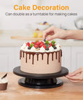 Person decorating a cake on an 11 Inch Rotate Turntable For Cake Decorating And Painting With Smooth Ball Bearing Spin And 360 Degree Rotation Black Lightweight Display Stand For Spinning Spraying Decorating And Sculpting Projects By Kootek.