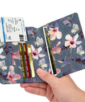 Slim RFID Passport Holder Travel Wallet With Card Slots, Blooming Hibiscus Design in hand; open view with cards and passport.