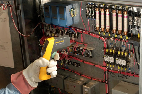 Boss Level HVAC Pro Infrared Thermometer With Dual Infrared And Thermocouple Modes, Reads Minus Forty To One Thousand Twenty Two Degrees Fahrenheit (Forty To Five Hundred Fifty Celsius), Perfect For HVAC And Refrigeration, Electrical, And Industrial Work. Handheld infrared thermometer measuring an electrical control panel.