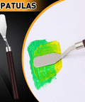 All In One Vinyl Weeding Toolkit For DIY Crafters showing spatula applying paint on canvas, part of 33-piece set for scrapbooking and lettering.