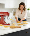 Woman using All In One Pasta Press Attachment For Stand Mixers With 7 Interchangeable Plates for fresh pasta at home.