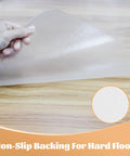 Hand holding clear Heavy Duty Office Chair Mat For Hardwood And Tile Floors Easy Glide Under Desk Protector