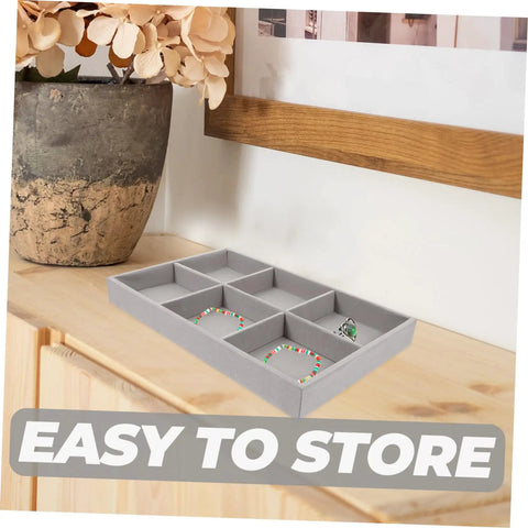 Sleek Three Piece Multi Compartment Jewelry Organizer Tray With Supple Velour Finish For Earrings Rings And Necklaces on a wooden dresser.