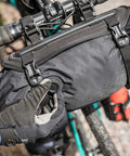 Cyclist adjusting air release on Frontloader 8 Liter Bar Bag For Bike Handlebar Mount, waterproof gear carrier shown on handlebars