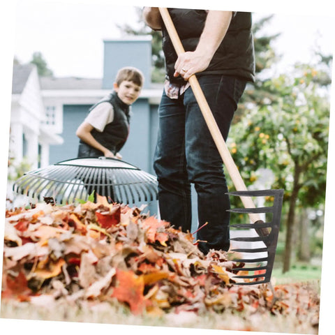 Heavy Duty Soil Rake For Gardening And Farming Plowing Aerating And Mixing Soil Tough As Nails Durable Steel Rake Tool For Garden Maintenance And Farm Use Dark Grey Finish With Strong Tines in use with fall leaves