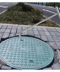 Beefy Steel Manhole Cover Hook With Smart Leverage For Hassle Free Septic Tank Removal And Rust Proof Finish That Slays Heavy Labor And Keeps Your Crew Rolling Smooth Everyday lifting a green manhole cover.