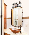 Vintage Style Three Light Indoor Vanity Light Fixture In Oil Rubbed Bronze With Barnwood Accents And Hand Blown Clear Seeded Glass over mirror