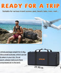 Man with Ultra Portable 1.9L Aluminum DOT Certified Scuba Tank and travel case on rocky shore next to ocean.