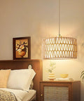 Level Up Your Chill Zone With This Hand Woven Rattan Plug In Pendant Light Farmhouse Hanging Lamp from a bedside view.