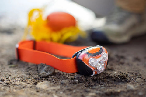 Orange Nautical Safety Kit For Paddle Sports And Boating with waterproof headlamp and floating rope on ground