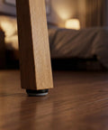 Close-up of a chair leg with 12 Piece Nail On Chair Leg Sliders For Hardwood Floors Heavy Duty Plastic And Metal Floor Protectors.