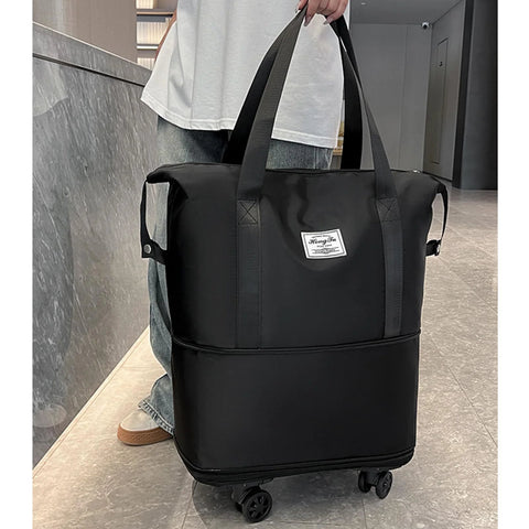 Black rolling duffle bag with dual top handles, wheels, and a front brand patch