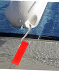 Pool float hanger hook with orange grip attached to a white pool float, angled view.