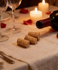 25 Pack Natural Soft Wood Corks, Tapered Bottle Stoppers on elegant dining table with wine and candles