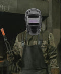 Worker in camouflage holding welding tools wearing a helmet, showcasing Upgrade Your Welding Game With 3pc 2.0 Magnification Lenses For Most Helmets Durable Pc Plastic Protective Shields Built To Last And Provide Super Clean Views Every Time You Hit The Torch.