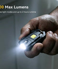 Hand holding Pocket-Sized Keychain Flashlight 500 Lumens Ultra-Compact EDC Light, illuminating with bright beam