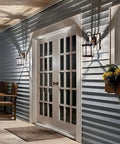 Durable Outdoor Wall Light In Black Finish With Clear Beveled Glass, 1 Light Exterior Sconce on porch at night