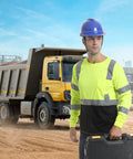 Kickass High Visibility Class 3 Hi Vis Safety Shirt With Reflective Strips And Pocket Long Sleeve Quick Dry Mesh Workwear For Construction Jobs Built Tough And Sweat Free For Active Crews In Lime And Black worn by a man holding a toolbox at a construction site.