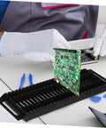Person placing a PCB into a Six Pack Circuit Board Rack Antistatic Holder Stand for PCB Storage and Display Durable Groove Design.