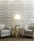 PVC 3D Wall Tile Flowing Wave White Paintable Panel Kit 19.7 By 19.7 Inches Pack Of 12 Covers 32 Sq Ft Waterproof Fire Resistant Easy DIY Install Lightweight Yet Durable Home Reno Accent installation in living room with modern decor and two gray armchairs.