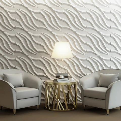 PVC 3D Wall Tile Flowing Wave White Paintable Panel Kit 19.7 By 19.7 Inches Pack Of 12 Covers 32 Sq Ft Waterproof Fire Resistant Easy DIY Install Lightweight Yet Durable Home Reno Accent installation in living room with modern decor and two gray armchairs.