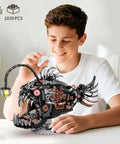 Boy assembling Mechanical Anglerfish Building Kit For Adults With Light Display 1038 Piece Set Steampunk Ocean Creature Blocks.