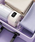 Portable Mini Washing Machine Cordless Compact Laundry Spin Dryer in a drawer, with fabrics stacked neatly around.