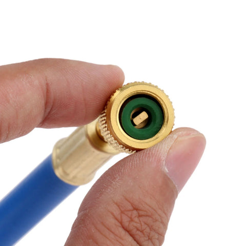 Close-up of brass 1/4-inch SAE refrigerant charging hose fitting with green seal and knurled edge
