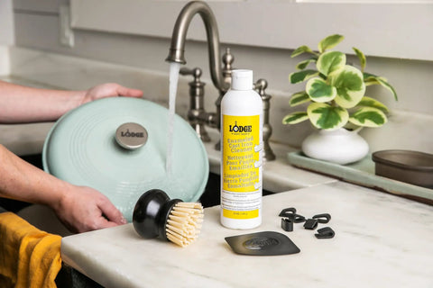 Enamel Enameled Cast Iron And Ceramic Stoneware Care Kit With 11oz Cleaner, Black Pan Scraper, Scrub Brush, Pot Protectors, Use And Care Booklet, 5 Piece Set For Easy Cookware Maintenance on sink counter