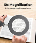 Hands Free Desk Magnifier with Light and Clamp showing 10X real glass lens magnifying text in a book