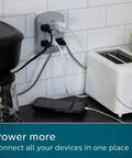 Six Outlet Surge Protector Extender, 900 Joules, 3-Prong Wall Tap in use with multiple devices in kitchen setting