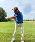Golfer using Golf Belt Laser And Rod Mount For Swing Training And Putting Alignment Securely Attaches To Back Chest Or Hip outdoors.
