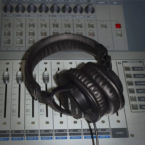 Closed Back Studio Mixing Headphones With 40mm Neodymium Drivers on a soundboard, showing padded headband and ear cushions.