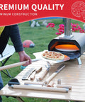 7 Piece Pizza Oven Tools Kit For Home And Outdoor Ovens With Pro Grade Stainless Steel Pizza Peel Oven Brush Bubble Popper Turner Rocker Cutter Dough Roller And Scraper visible on a table beside a pizza oven