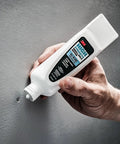 No Sweat Wall Patch Tube being applied to a nail hole on a wall, showcasing built-in applicator wand and high strength spackle.