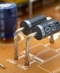 Close-up of diodes on a circuit board from Diode Assortment Kit For Electronics Hobbyists And Makers Featuring 1N4001 Through 1N4007.